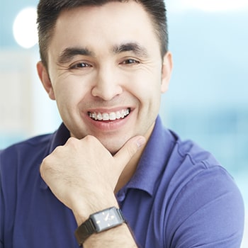 A man with transparent braces smiling