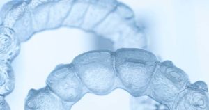 Images of clear aligners on a grey background