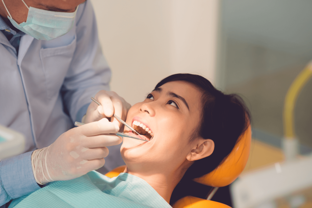 A patient is in a dentist’s chair for a routine examination